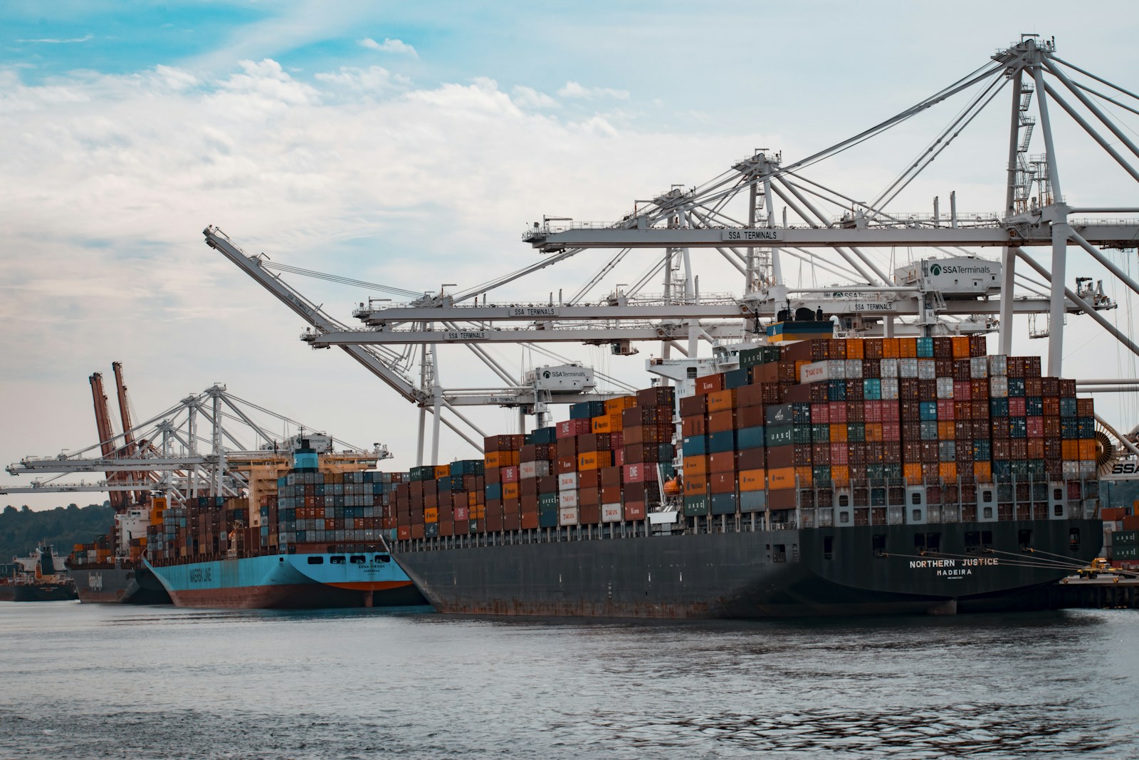Container ship stacked with shipping containers at sea, inbound freight in transit