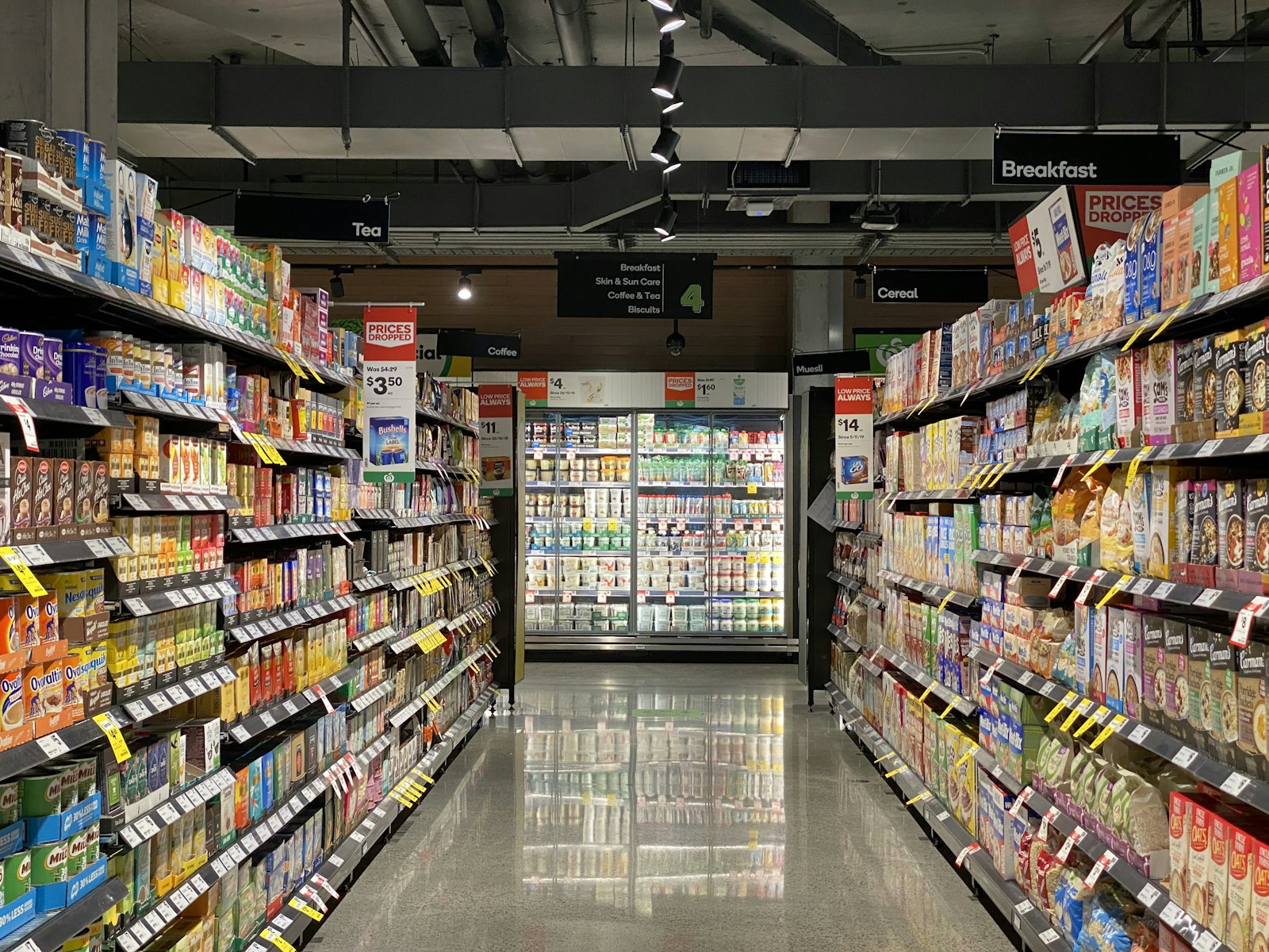 Grocery store aisle with packaged products on metal shelves