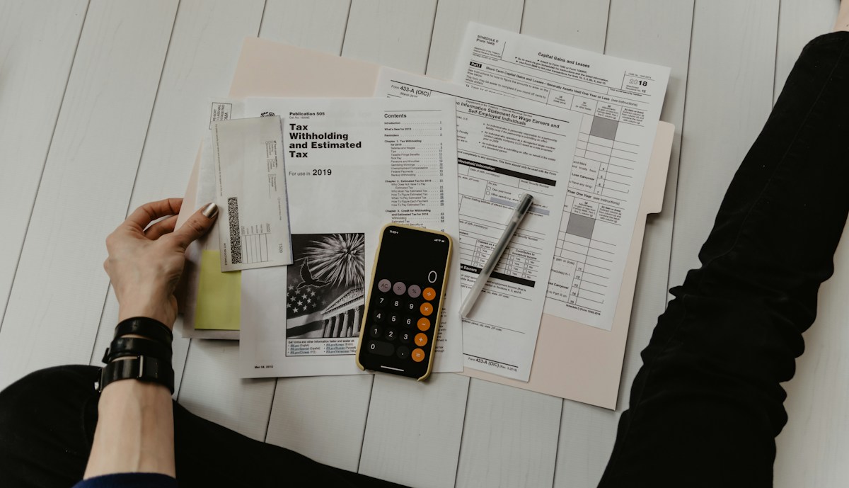 Person reviewing financial documents and invoices at a desk